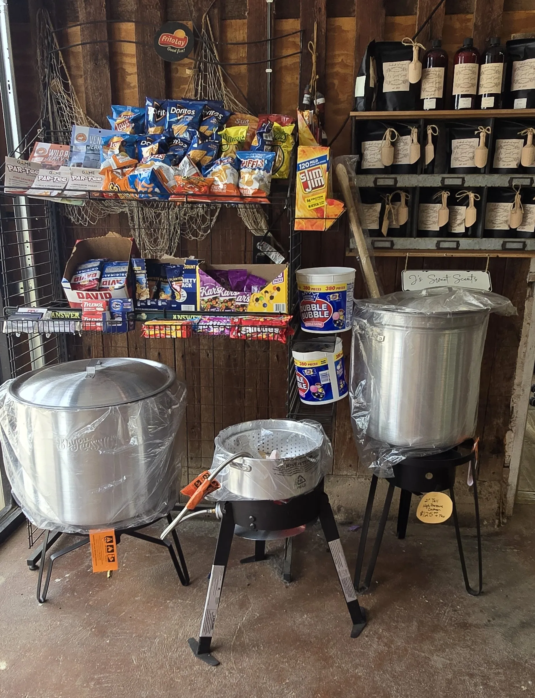 Stock pots and outdoor fryers displayed inside Red Barn