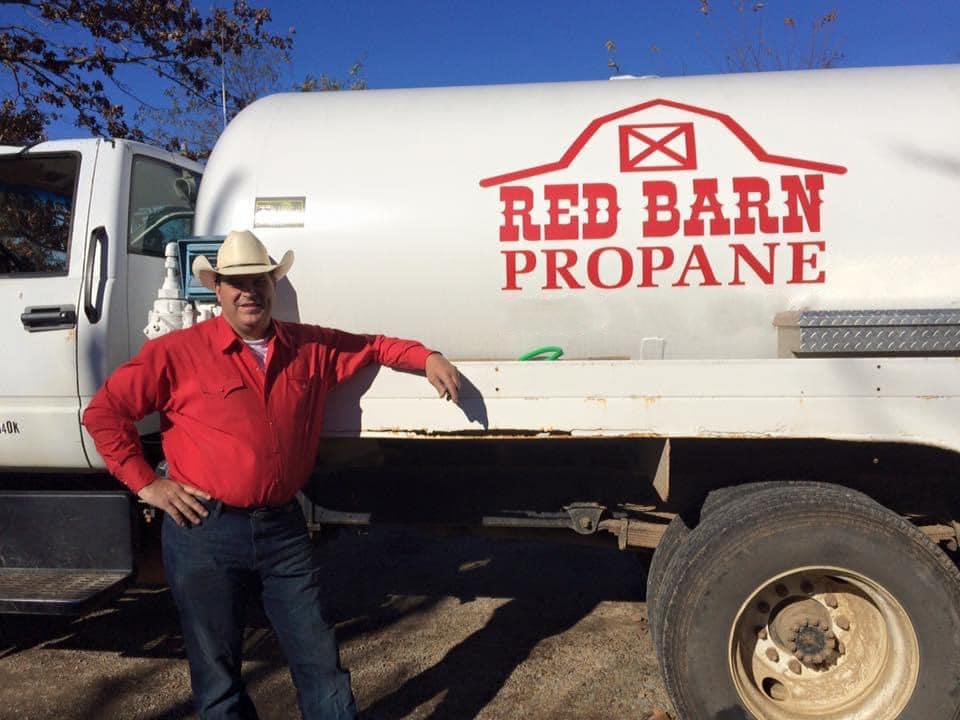 Red Barn owner standing next to a propane truck